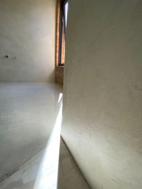 Close-up of smooth microcement wall and floor